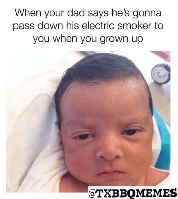 A funny family-themed bbq meme from @TXBBQMEMES featuring a close-up of a highly skeptical, unimpressed newborn baby reacting to text about their dad promising to pass down his electric smoker when they grow up.