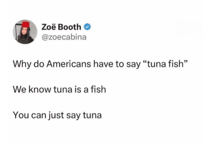 A linguistic british meme tweet from Zoë Booth questioning why Americans say "tuna fish" instead of just "tuna," dryly noting that everyone already knows tuna is a fish.