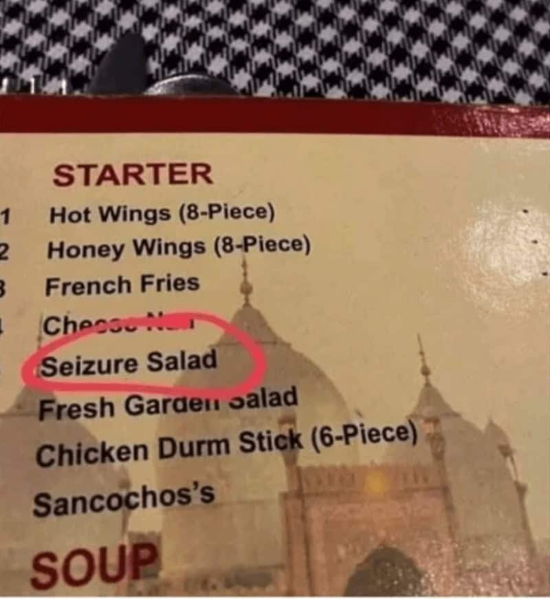 restaurant menu features a hilarious typo for a Seizure Salad instead of the intended caesar salad meme dish.