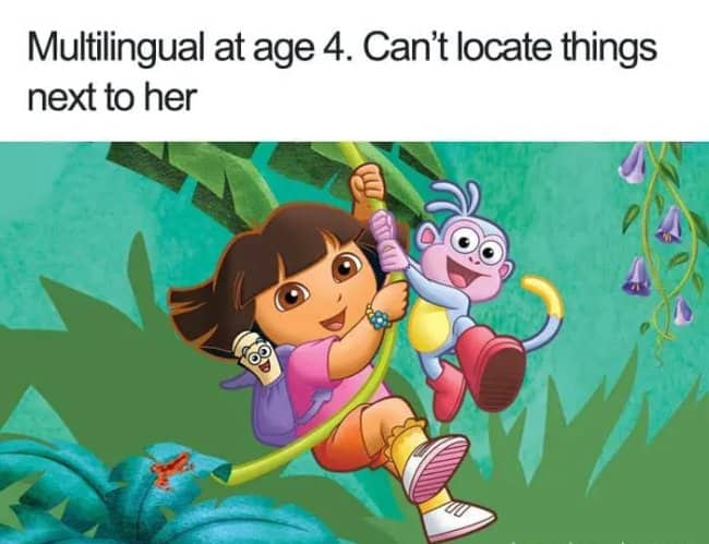 Dora the Explorer from the cartoon show is swinging from a jungle vine with her monkey friend Boots. Text: "Multilingual at age 4. Can’t locate things next to her".