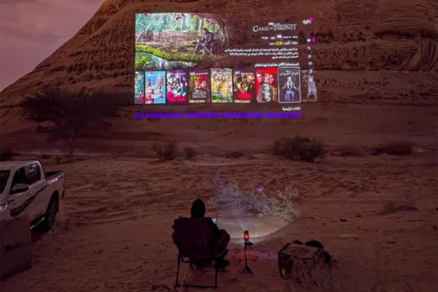 Chill spots for dudes gallery capturing the diverse landscapes of relaxation, featuring a movie projected onto a massive desert mountain, the improvised genius of passing espresso between alleyway windows on a board, and a dapper cat in a bowtie claiming his territory.