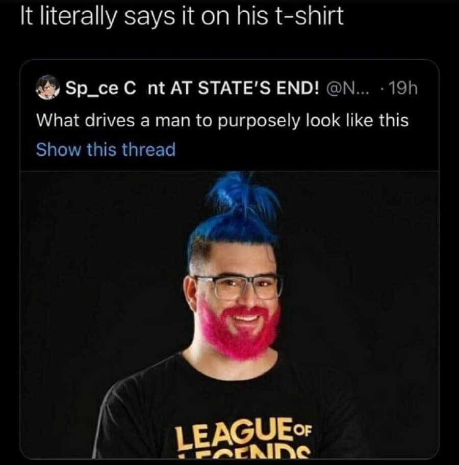 A screenshot roasts a man sporting neon blue hair tied in a high topknot paired with a bright magenta beard while wearing a League of Legends t-shirt, acting as a legendary internet culture classic meme.