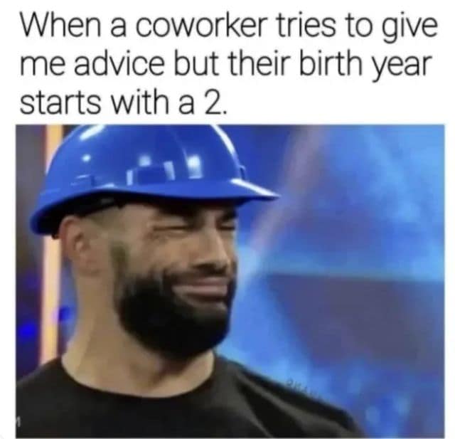 A workplace comedy graphic features WWE wrestler Roman Reigns wearing a blue plastic construction hard hat and squinting skeptically under text about receiving advice from a coworker born in the 2000s, framing a viral classic meme.