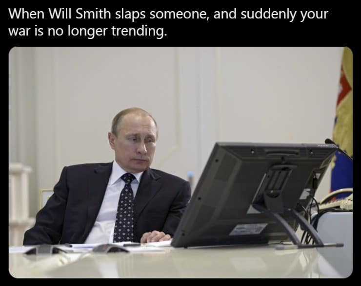 A topical classic meme featuring Vladimir Putin looking dejected at a computer screen, with text describing the moment the 2022 Will Smith Oscar slap stole the global news spotlight from his military actions.