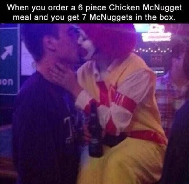A chaotic night-out classic meme features a blurry image of a person dressed in a full Ronald McDonald costume passionately kissing a man at a bar, paired with the caption: "When you order a 6 piece Chicken McNugget meal and you get 7 McNuggets in the box."