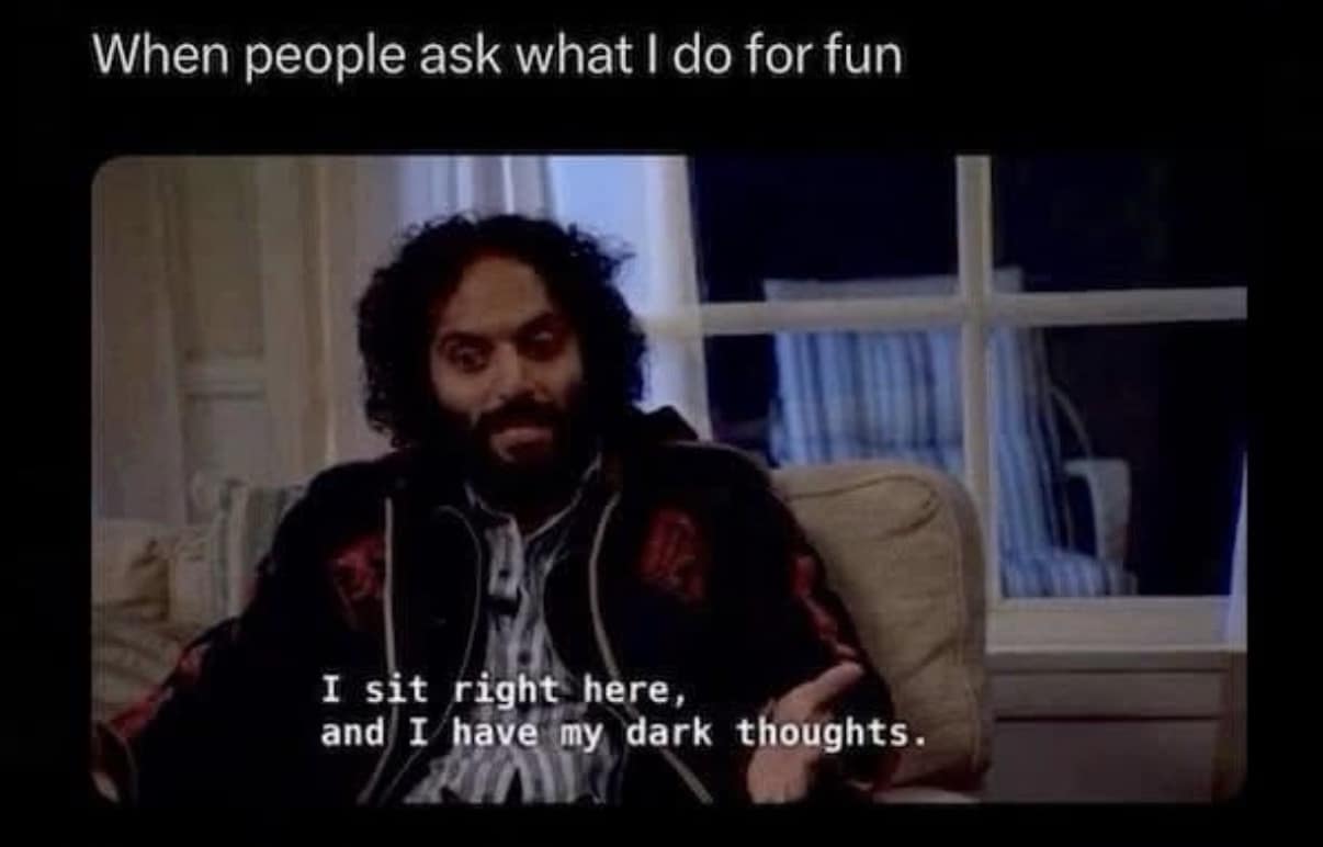 classic meme featuring Derek from The Good Place sitting alone in a darkened room. The subtitle reads, "I sit right here, and I have my dark thoughts," used to describe what introverts actually do when people ask what they do for fun.