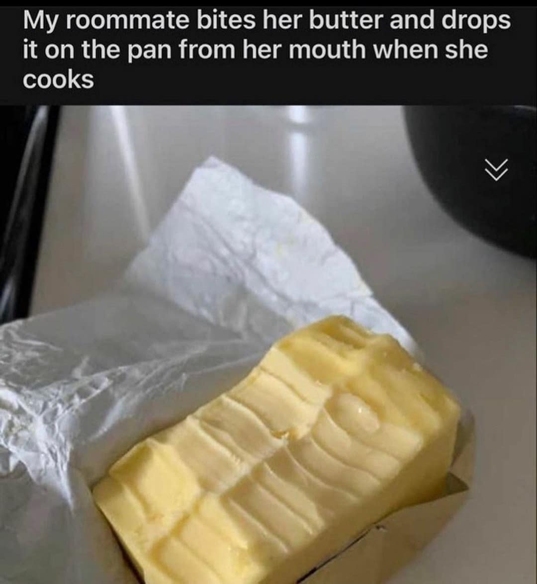 A cursed classic meme image showing a block of butter with deep human teeth marks bitten directly into the top. The caption claims their roommate "bites her butter and drops it on the pan from her mouth when she cooks."