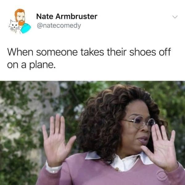 A travel-etiquette text tweet from user Nate Armbruster acts as an elite classic meme, pairing a prompt about passengers removing their shoes on an airplane with an image of Oprah Winfrey raising both hands defensively with a look of extreme disgust.