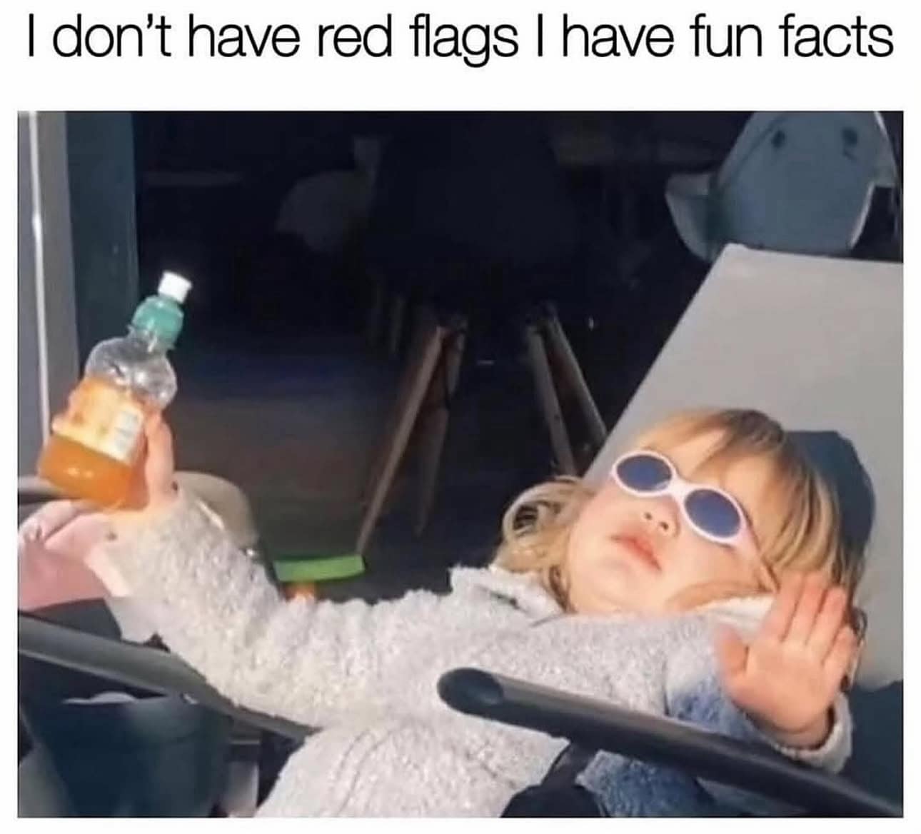 A sassy toddler wearing retro white sunglasses and lounging like a celebrity, paired with the iconic quote: "I don't have red flags I have fun facts."