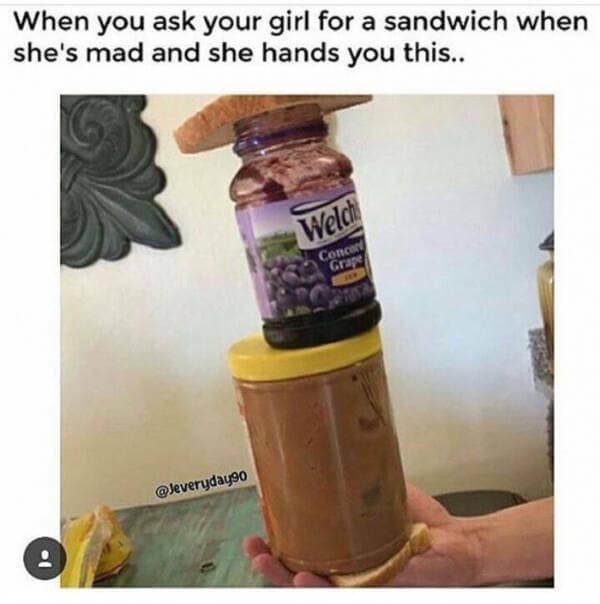 vertical stack of unopened peanut butter and jelly jars balanced on a single slice of bread, representing a classic meme about relationship pettiness.