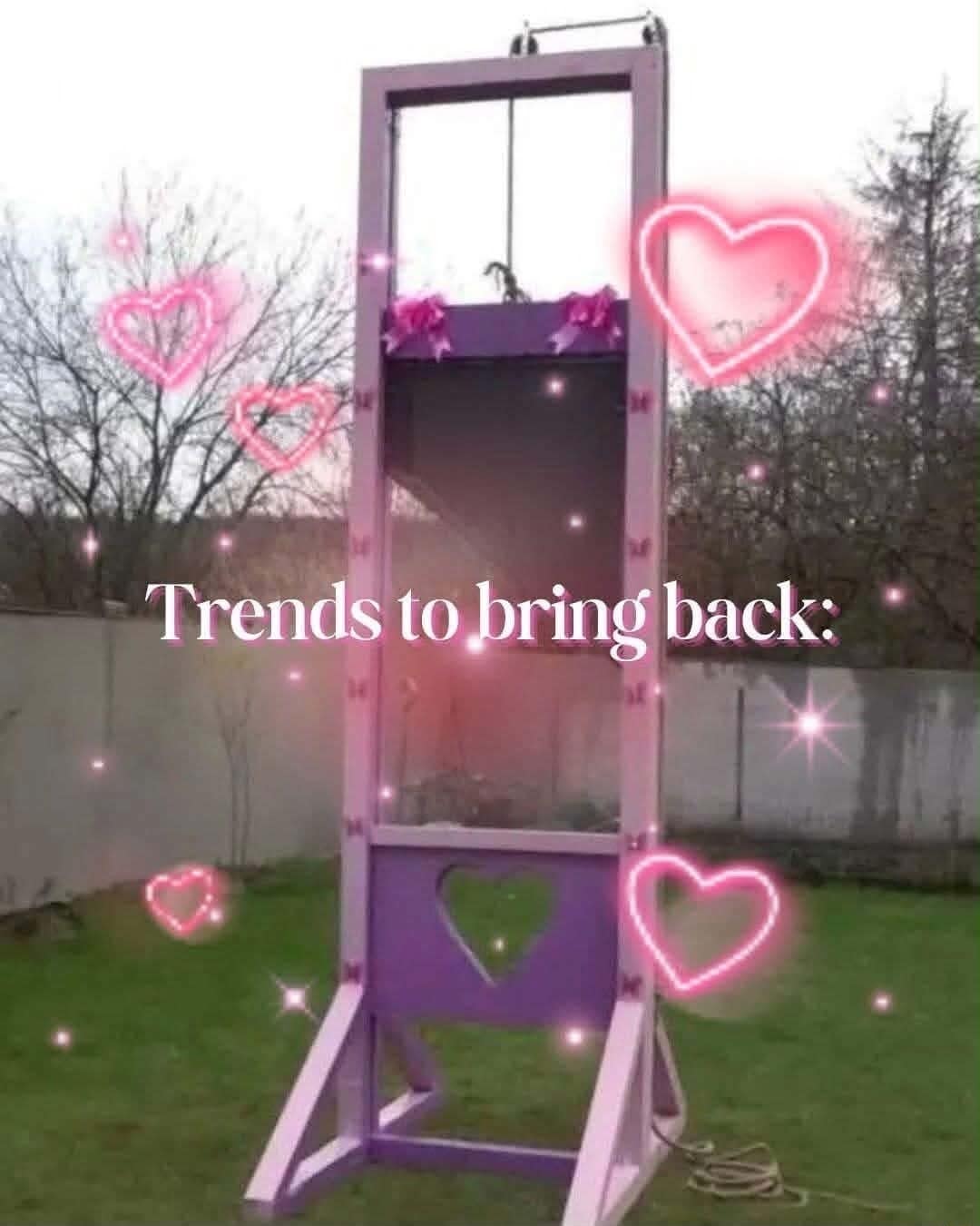 classic meme featuring a full-sized wooden guillotine painted in soft purples and pinks, decorated with glitter, sparkles, and glowing pink heart emojis under the heading "Trends to bring back."