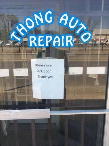hilariously unfortunate classic meme of a storefront window for "Thong Auto Repair," with a printed sign taped below it that reads: "Please use Back door Thank you."