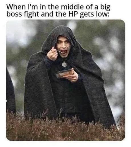 A classic meme featuring Henry Cavill as Geralt of Rivia from The Witcher huddled in a heavy cloak and aggressively eating from a plastic takeout container in the middle of a field.