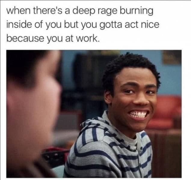A highly relatable classic meme featuring Donald Glover as Troy Barnes from Community making a forced, pained, and wide-eyed smile while staring off-camera, captioned with the struggle of acting nice at work while feeling deep rage.