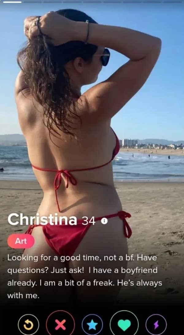 A cringy tinder profile for 34-year-old Christina displays a beach photo of her in a red bikini from behind, paired with a contradictory bio stating she wants a good time but already has a boyfriend who is "always with me."