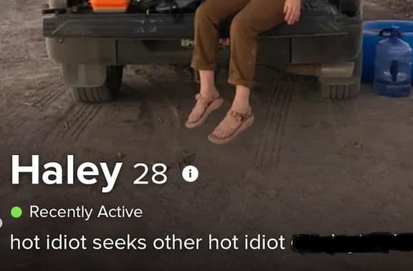 A cringy tinder profile for 28-year-old Haley shows legs dangling off a pickup truck tailgate in sports sandals under a deadpan bio reading, "hot idiot seeks other hot idiot."