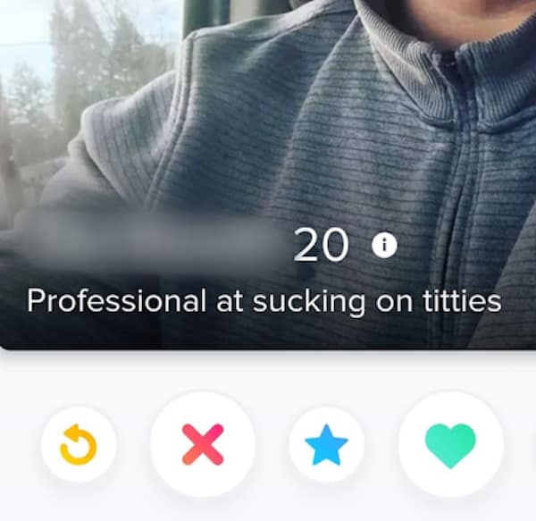 A cringy tinder profile for an anonymous 20-year-old male showcases a close-up photo of his chest in a grey textured quarter-zip sweater with a hyper-blunt bio line stating, "Professional at sucking on titties".