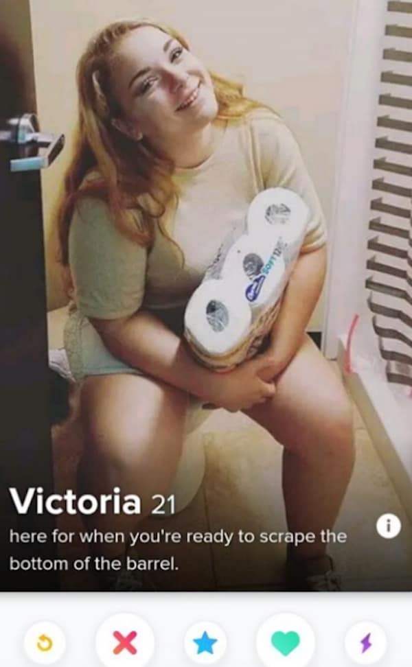 A funny dating app profile for 21-year-old Victoria features an incredibly bizarre photo of her smiling while sitting on a toilet clutching a bulk pack of toilet paper, captioned, "here for when you're ready to scrape the bottom of the barrel."