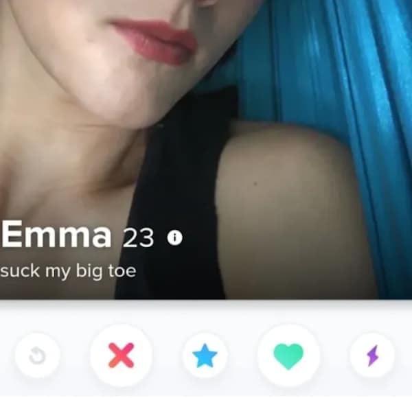 A close-up profile card functions as a cringy tinder profile for 23-year-old Emma, showing a tight crop of her face against a blue background with a blunt, one-sentence bio demand that reads, "suck my big toe."
