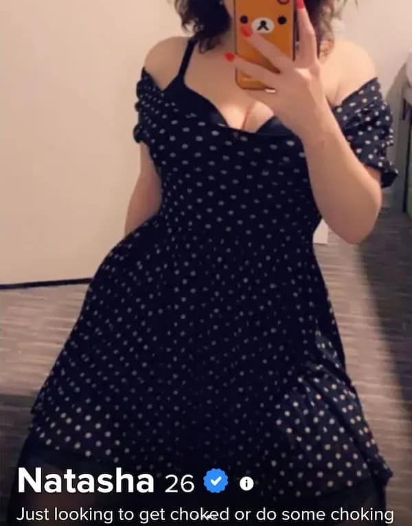 A mirror selfie functions as a striking funny dating app profile for 26-year-old Natasha cladded in a polka-dot dress, whose bio text gets straight to the point by declaring she is "Just looking to get choked or do some choking."