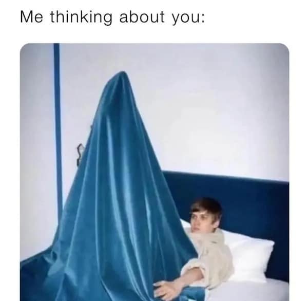 A classic, high-energy dirty meme showing a man sitting in bed with a giant, comically sharp blue sheet tent rising from his lap, captioned: "Me thinking about you."