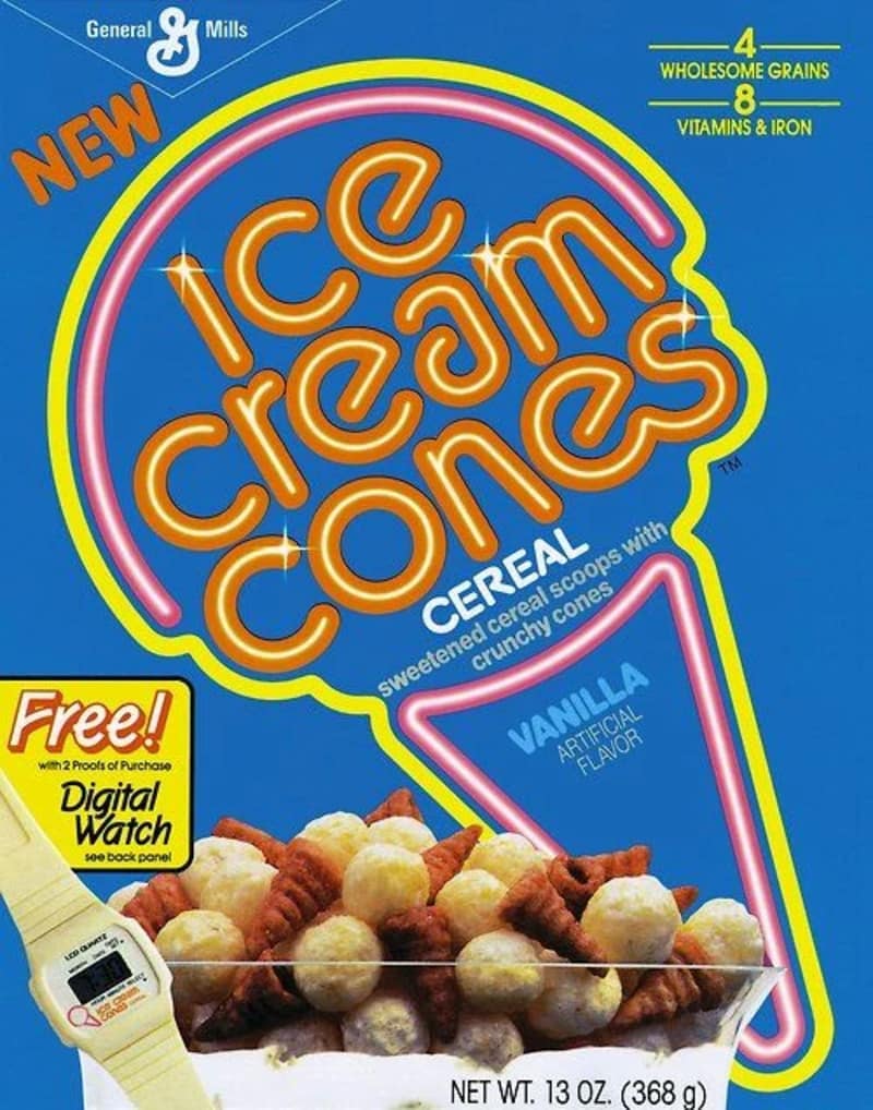 A retro blue box of General Mills Vanilla Ice Cream Cones cereal showcases a legendary entry in the archive of discontinued cereals, complete with a promotional image for a free digital watch prize at the bottom left.