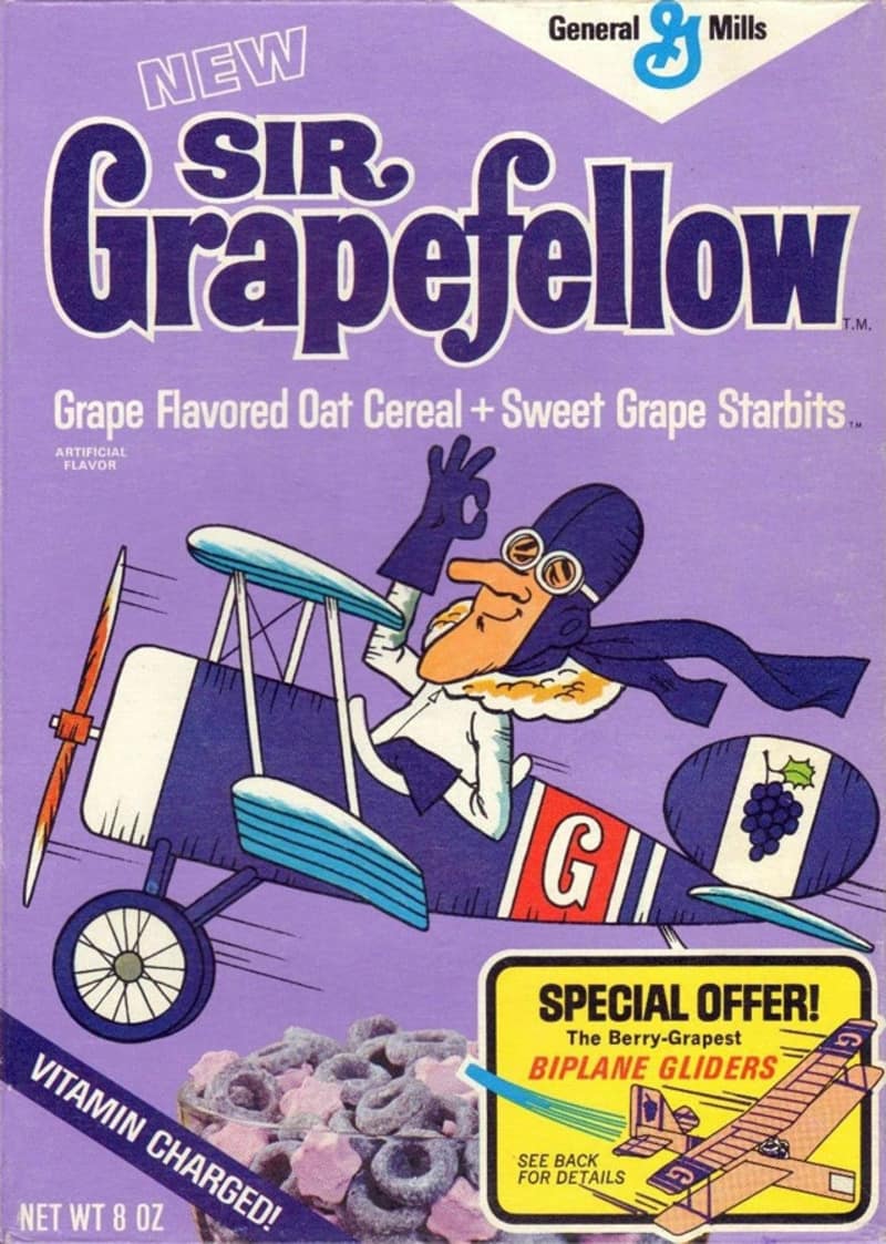 A rare 1970s purple box of General Mills Sir Grapefellow cereal preserves a historic example of discontinued cereals, featuring a cartoon British pilot mascot soaring in a biplane glider.