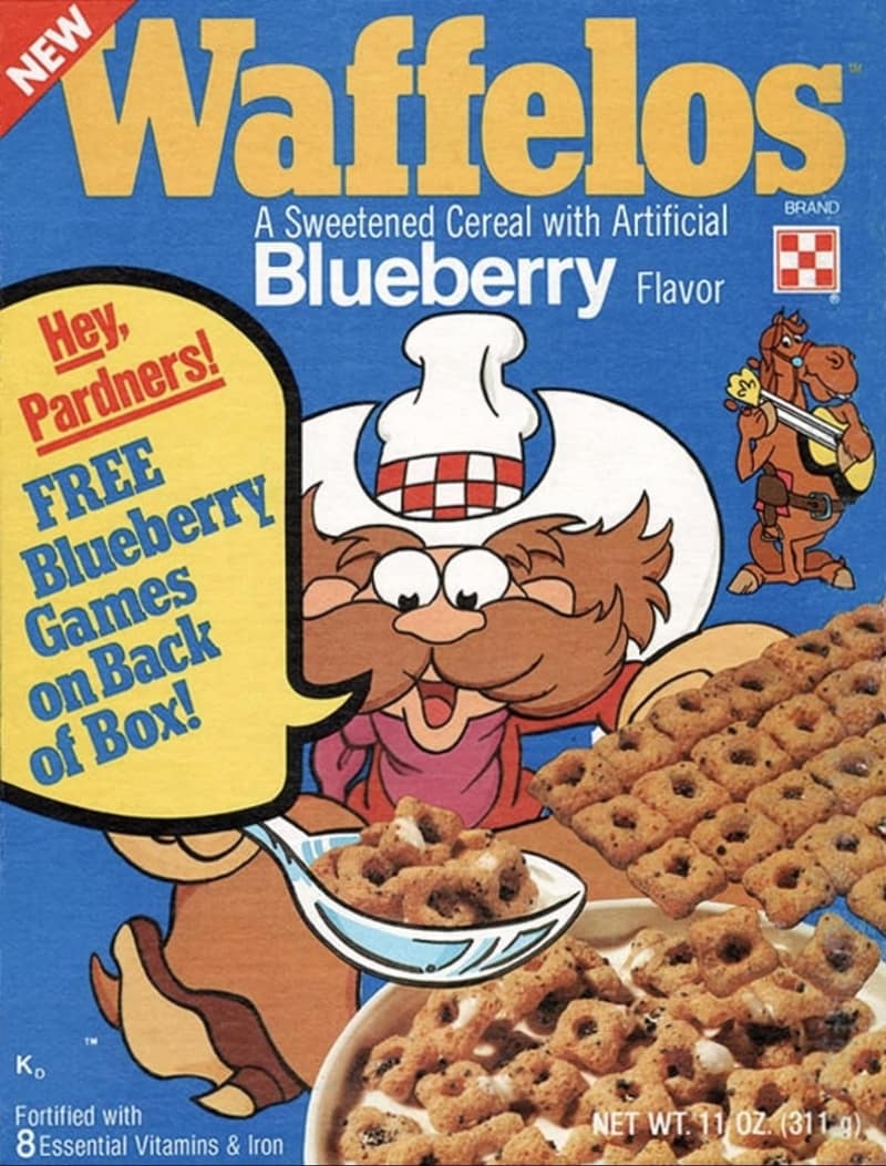 A classic retro box of Waffelos blueberry-flavored sweetened waffle grid cereal brings back a premium nostalgic cereal memory, featuring the cartoon cowboy mascot Waffelo Bill and his guitar-strumming horse.