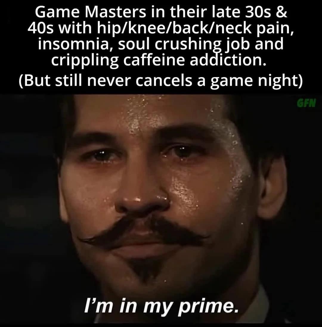 A historical drama screenshot features a sweating, exhausted Doc Holliday from Tombstone declaring "I'm in my prime" to create an accurate dnd meme roasting aging Game Masters who refuse to cancel game night despite full-body joint pain and crippling caffeine addictions.