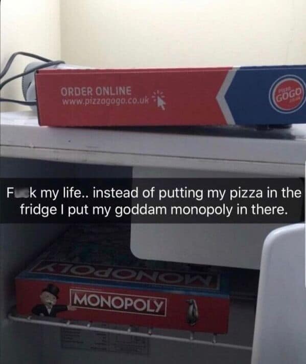 A Monopoly board game box accidentally placed inside a refrigerator instead of pizza.