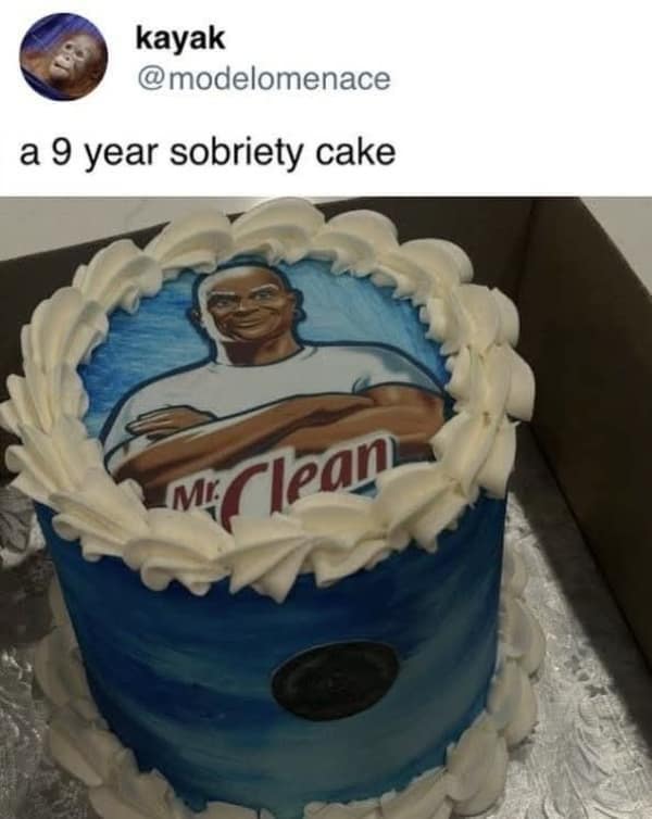 A custom celebration cake decorated with blue watercolor buttercream frosting and white ruffles features an edible photo print of the iconic Mr. Clean mascot to celebrate a nine-year sobriety anniversary milestone in a witty food meme.