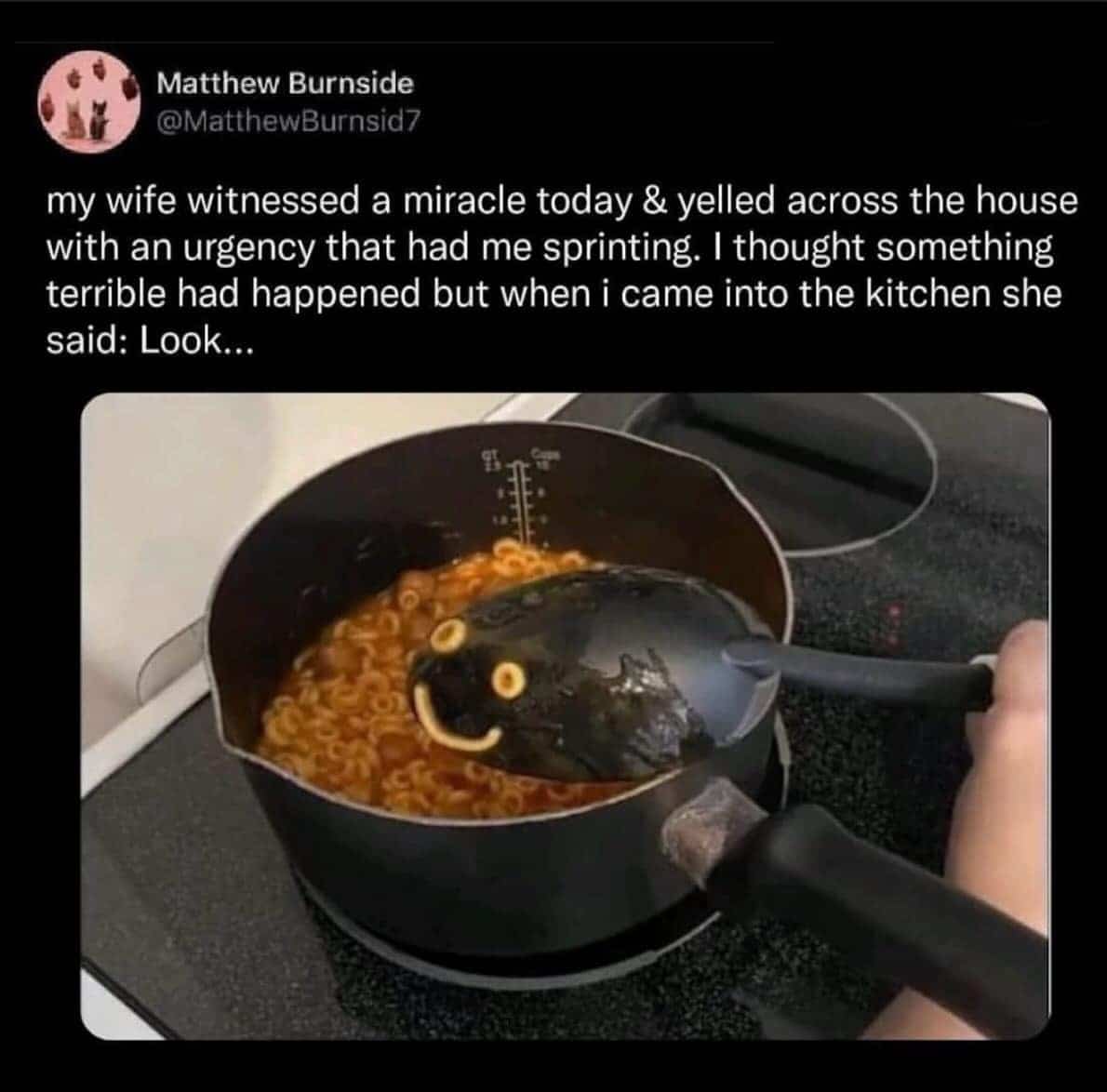 A pot of pasta with a ladle forming a perfect smiley face in the sauce.
