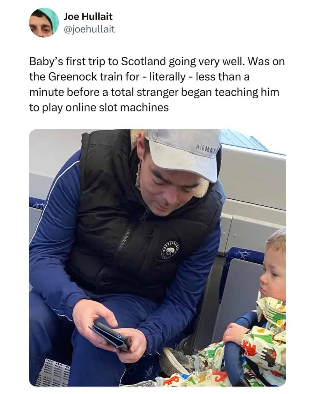A photo of a man on a Scottish train showing a baby how to use a gambling app as a classic British meme.