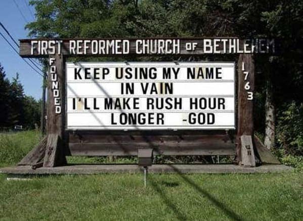 An old-fashioned wooden sign for the First Reformed Church of Bethlehem featuring a humorous quote from God threatening to lengthen rush hour if people continue using his name in vain.