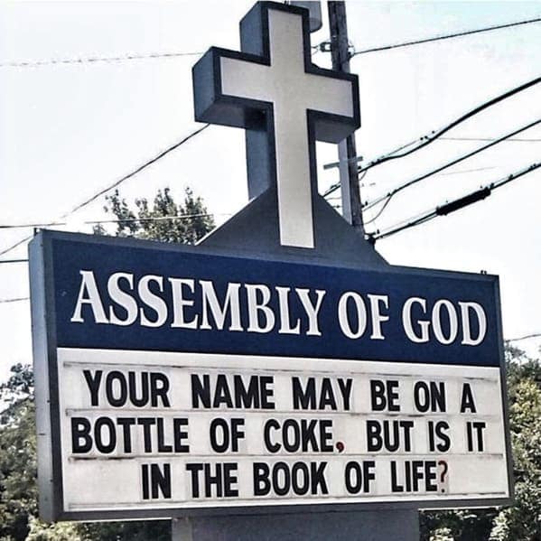 A tall blue and white sign for Assembly of God that uses a clever pop culture reference to the Share a Coke campaign to ask if a person's name is in the Book of Life.