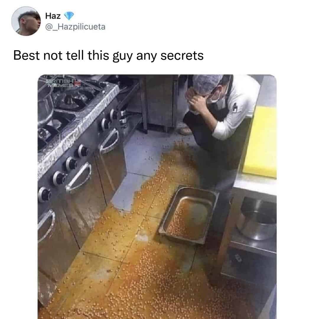An image of a distressed chef looking down at a massive spill of baked beans on a kitchen floor.
