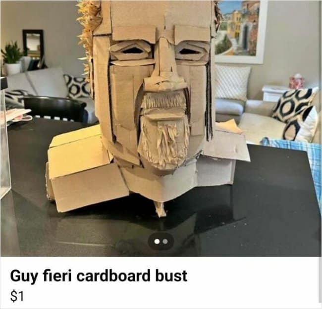 A highly detailed, multi-layered cardboard sculpture bust capturing celebrity chef Guy Fieri with his iconic spiky hair and goatee sits on a counter in a funny Facebook marketplace ad.