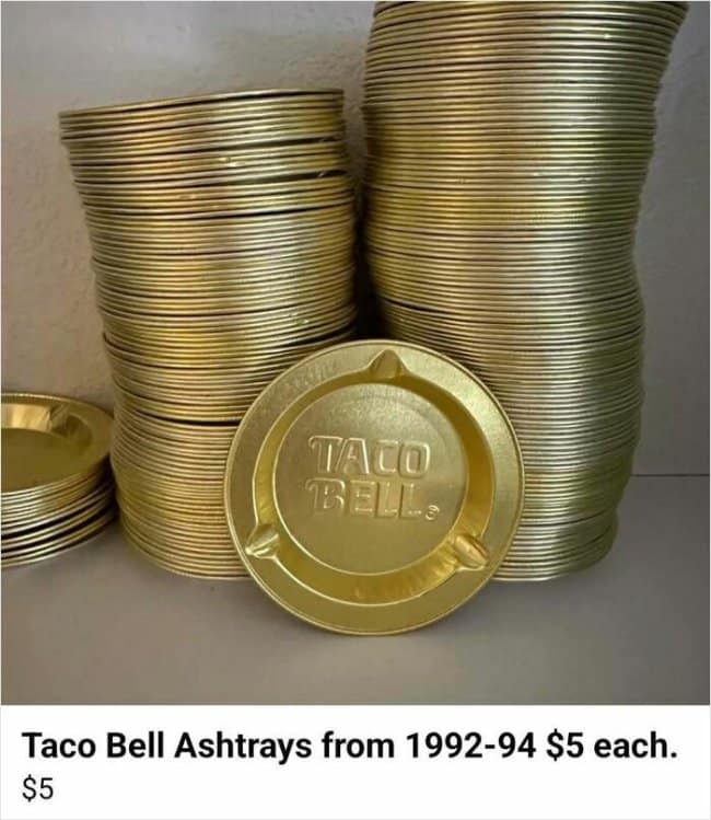 Massive stacks of golden vintage aluminum Taco Bell ashtrays embossed with the brand's retro bell emblem highlight a nostalgic funny Facebook marketplace ad tracking 1990s fast-food culture.