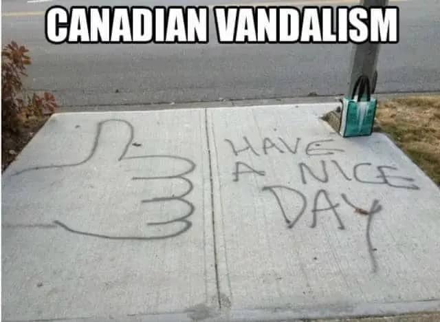 Mild sidewalk spray paint reading have a nice day with a giant thumbs up drawing.
