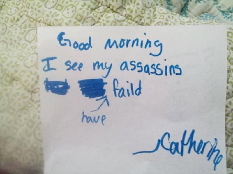 A terrifyingly elite morning greeting written in blue marker: "Good morning I see my assassins have faild," signed by a very confident Catherine.