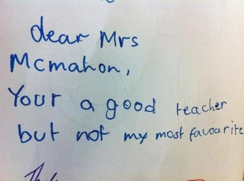 A funny kids note in blue ink addressed to Mrs. McMahon, bluntly informing her that she is a good teacher but "not my most favourite."