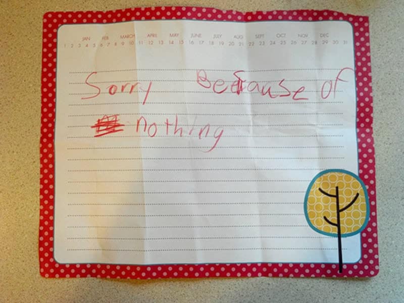 A funny kids note on decorative polka-dot paper that simply says "Sorry because of nothing," with "nothing" underlined for emphasis.