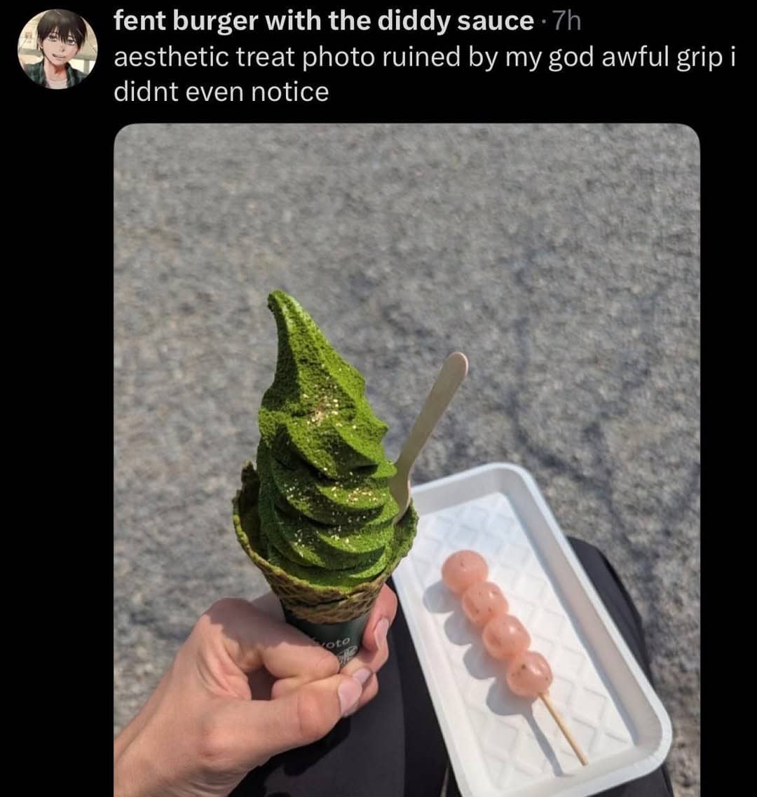 Aesthetic photo of matcha soft serve ice cream being held with a weirdly aggressive hand grip.