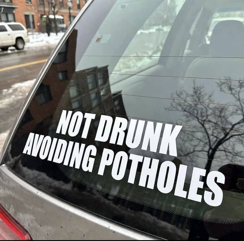 Car bumper sticker clarifying that the driver is not drunk but simply avoiding deep winter potholes