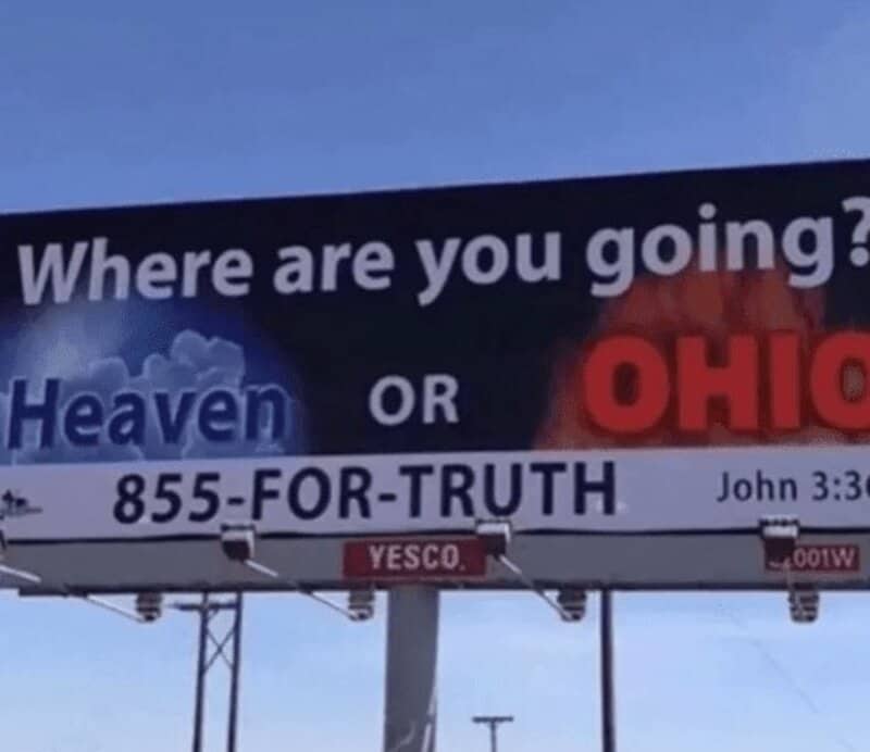 A massive highway billboard reading Where are you going? Heaven or Ohio?