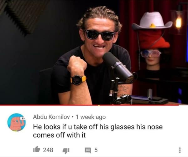 YouTube video screenshot of creator Casey Neistat wearing thick black sunglasses. A commenter provides a funny roast by suggesting his nose looks like it would come off with the glasses, like a Groucho Marx novelty mask.
