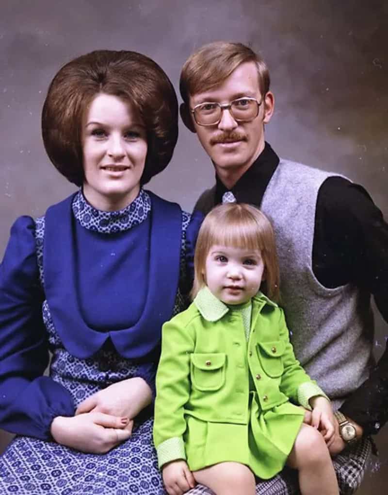 A family portrait with a woman in a massive beehive, holding a young girl in a plaid dress.