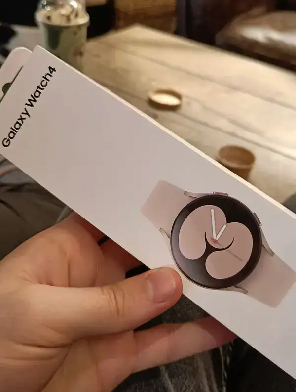 Closeup of a pink Samsung Galaxy Watch 4 box showing an abstract screen graphic.