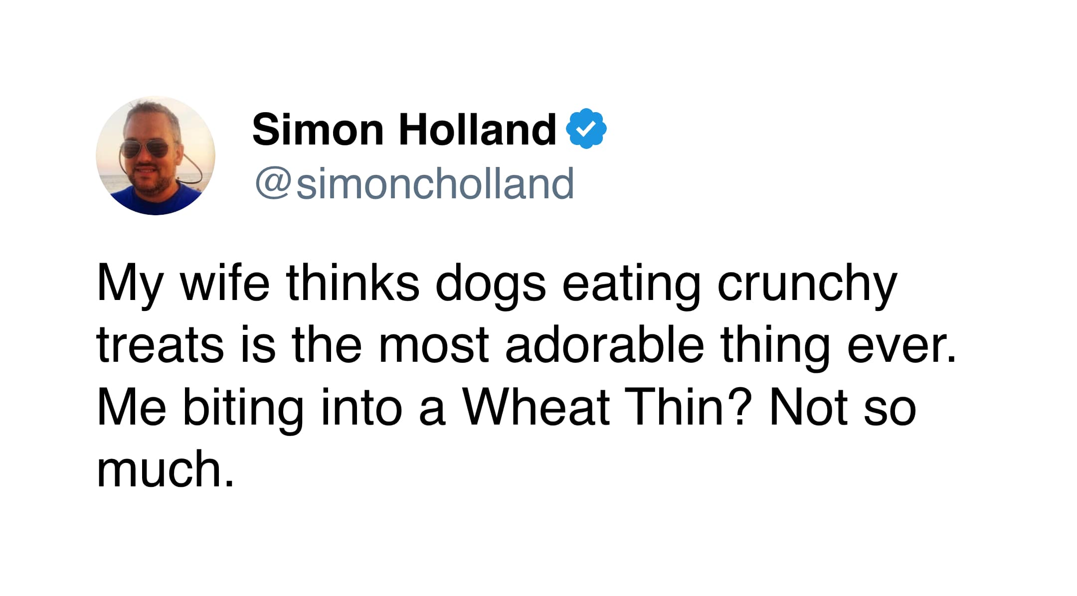 A sarcastic marriage meme tweet from Simon Holland pointing out the double standard between a dog eating "adorable" crunchy treats and a husband eating a noisy Wheat Thin.