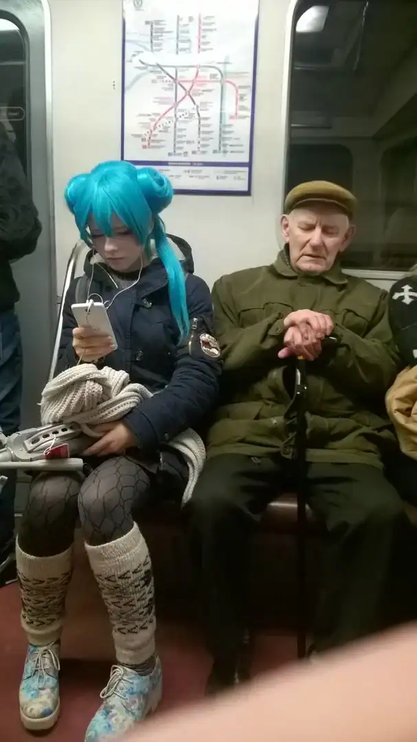 A surreal funny Russia picture of a Hatsune Miku cosplayer in full blue pigtails and anime gear sitting on a metro train next to a stoic, unimpressed elderly Russian man with a flat cap and cane.